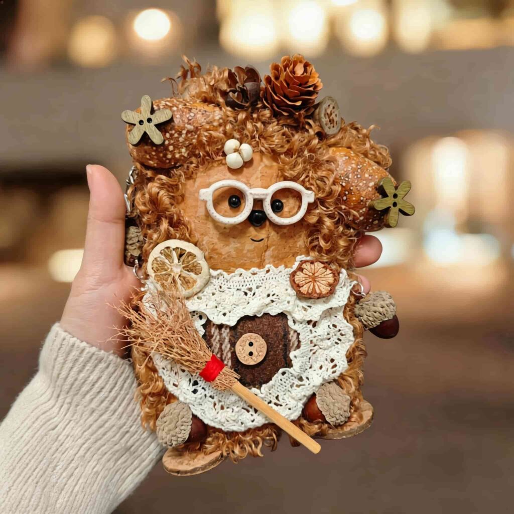 Hearthkeeper Bear Pod Doll finished doll held in hand with white glasses lace apron and tiny broom