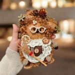 Hearthkeeper Bear Pod Doll finished doll held in hand with white glasses lace apron and tiny broom