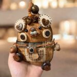 Finished Pod Doll – Button-Eyed Creature main image, showing circular eye discs and natural textures
