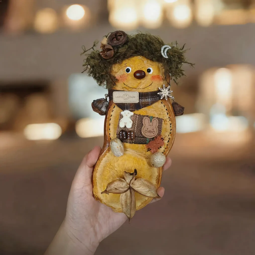Pod Doll – Mossy-Haired Yellow Scout, finished version with moss hair, rosy cheeks and red nose.