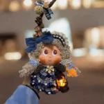 Finished Pod Doll featuring blue ribbon and seed-pod accents