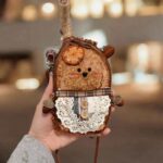 Finished Pod Doll handcrafted from seed pod with sunburst chest and stitched features