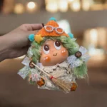 Finished Pod Doll with orange knit hat, white round glasses, and turquoise accents