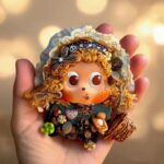 Finished Pod Doll with golden seed-pod hair held by hand