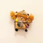 Pod Doll detail image showing face and yarn hair
