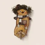 Detail view of the finished Pod Doll showing mossy hair and facial features.
