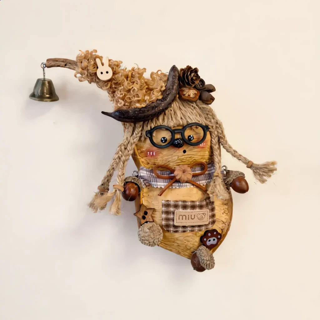 Close-up of the finished Pod Doll showing seed-pod texture, glasses, and beak features