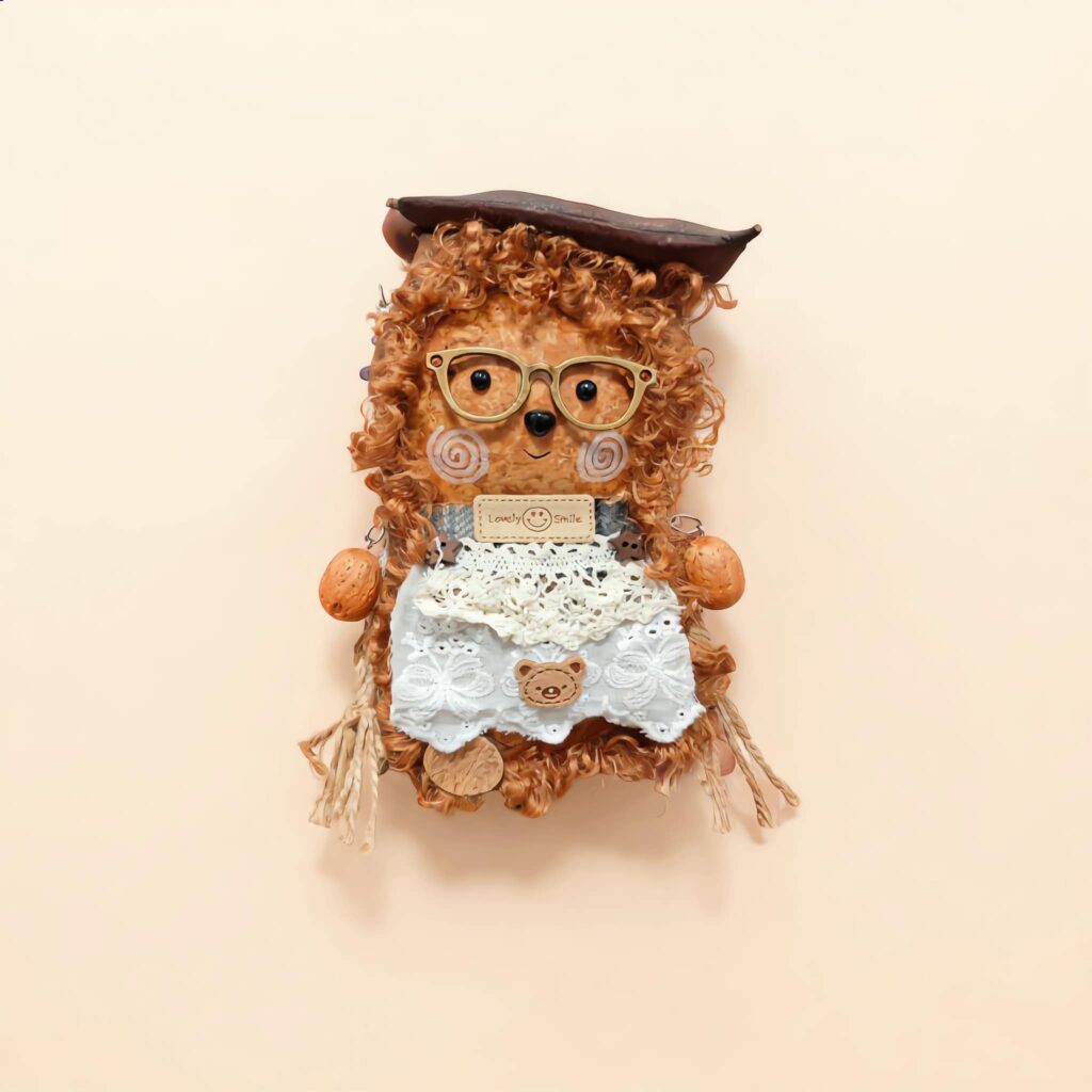 Detail view of the finished Pod Doll with curly fur and glasses.