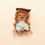 Detail view of the finished Pod Doll with curly fur and glasses.