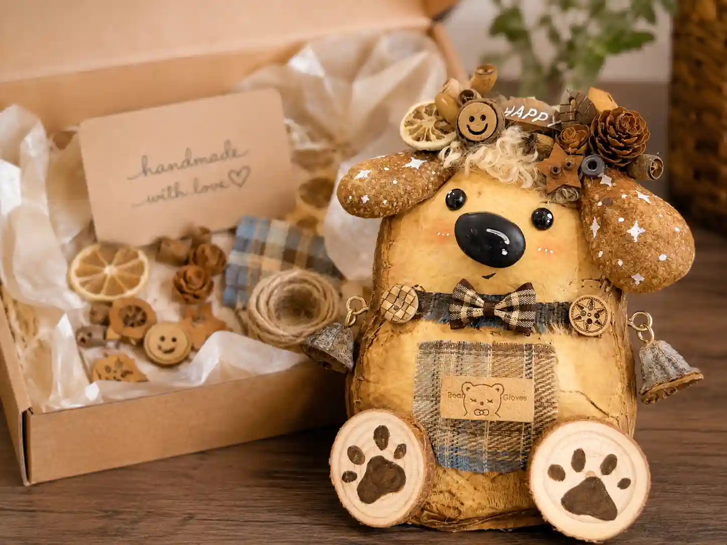 Finished handmade bear pod doll displayed beside a box of DIY-style materials and natural decorative parts