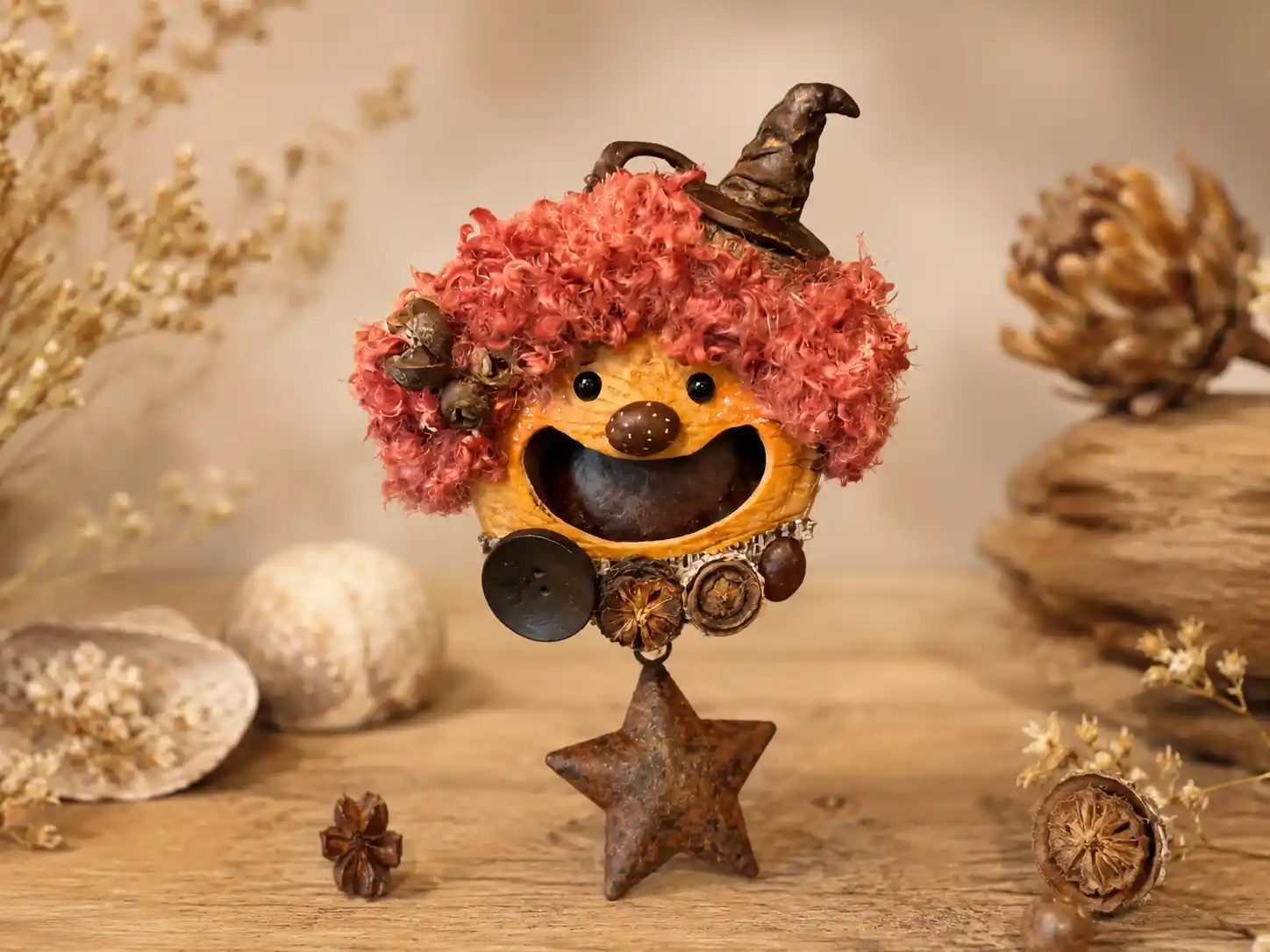 Finished red-haired handmade pod doll with a tiny witch hat, natural seed pod shell, and star charm