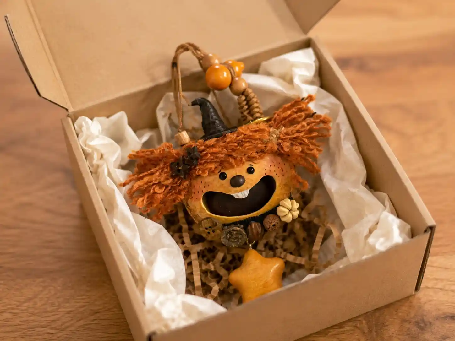 Handheld handmade pod doll showing dried natural seed pod shell, shell accent, beads, and small decorative details