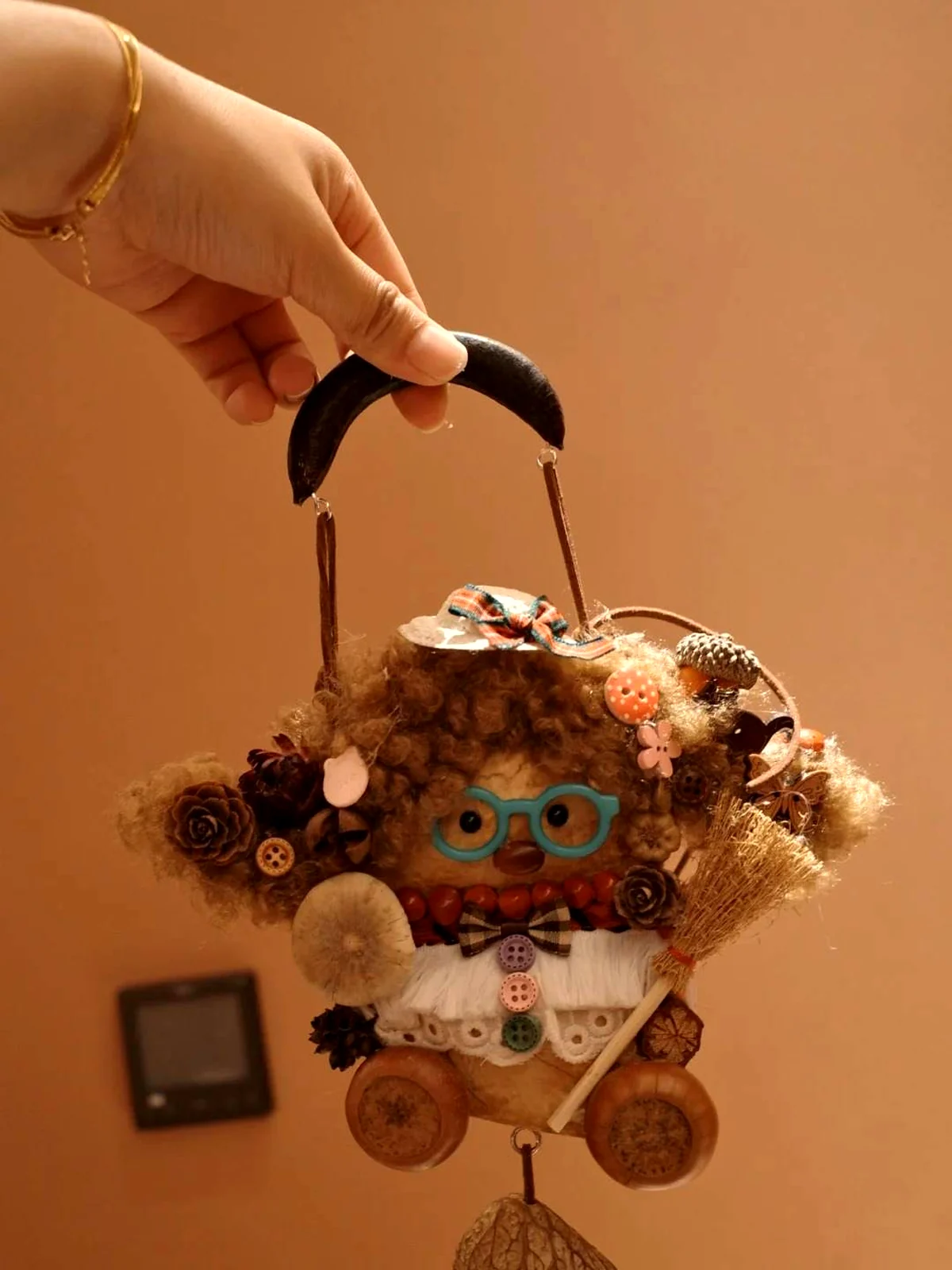Handmade pod doll being held as a small decorative collectible