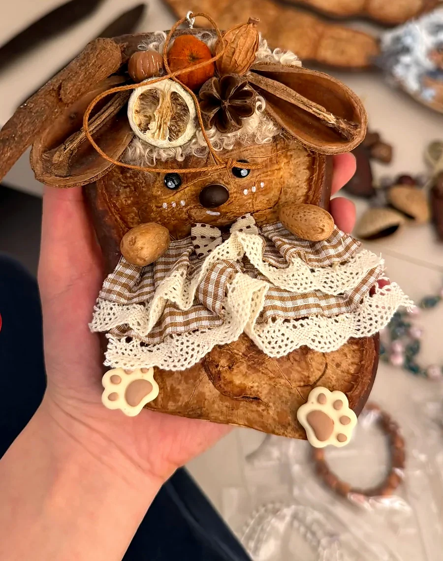 Handmade pod doll with delicate fabric and seed pod details