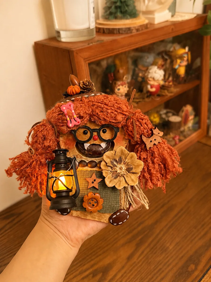 Handmade pod doll displayed near a wooden cabinet in a dry indoor space