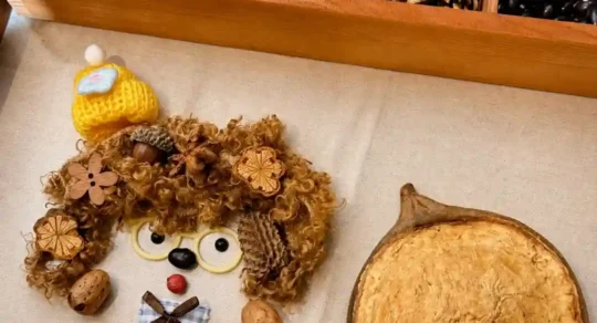 Handmade Poddoll parts arranged beside a natural seed pod shell before assembly
