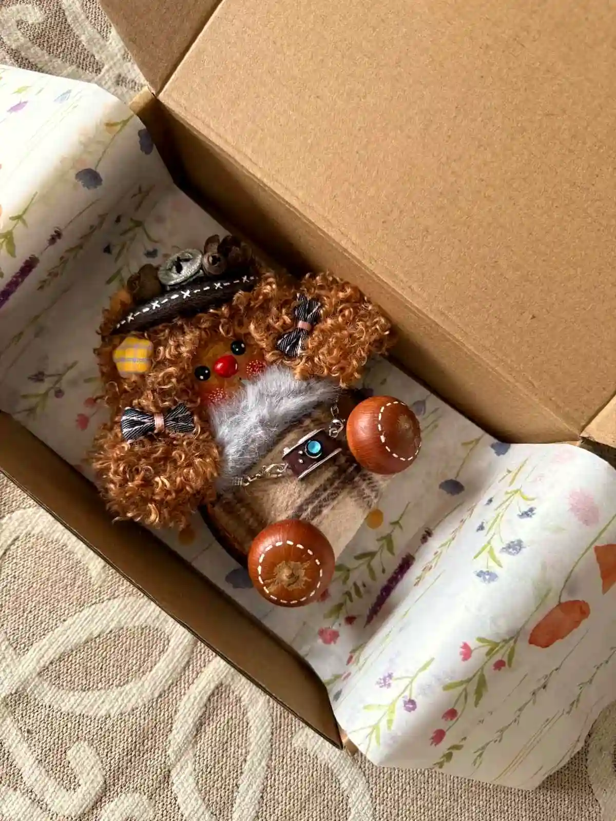 Handmade pod doll placed inside a gift box with floral wrapping paper