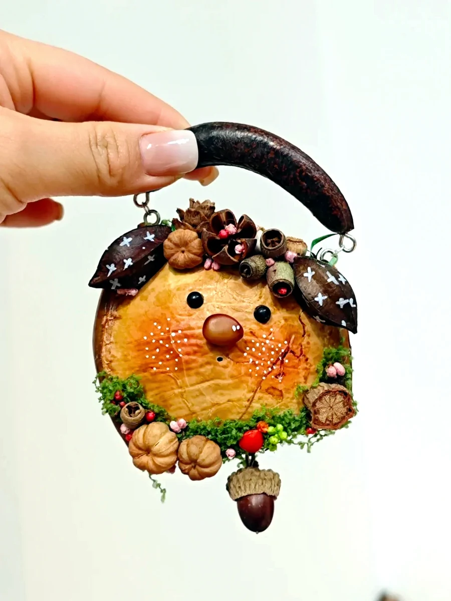 Front view of a handmade cat Poddoll ornament with natural details