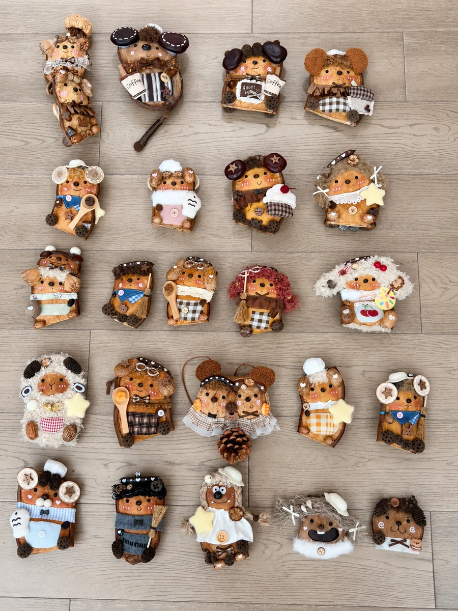 Large collection of handmade Poddoll characters arranged on a wooden floor