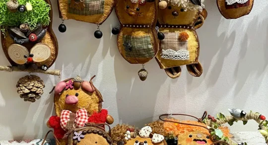 Early Poddoll experiments displayed on a studio wall and table with animal-inspired, human-like, hanging, and mixed characters