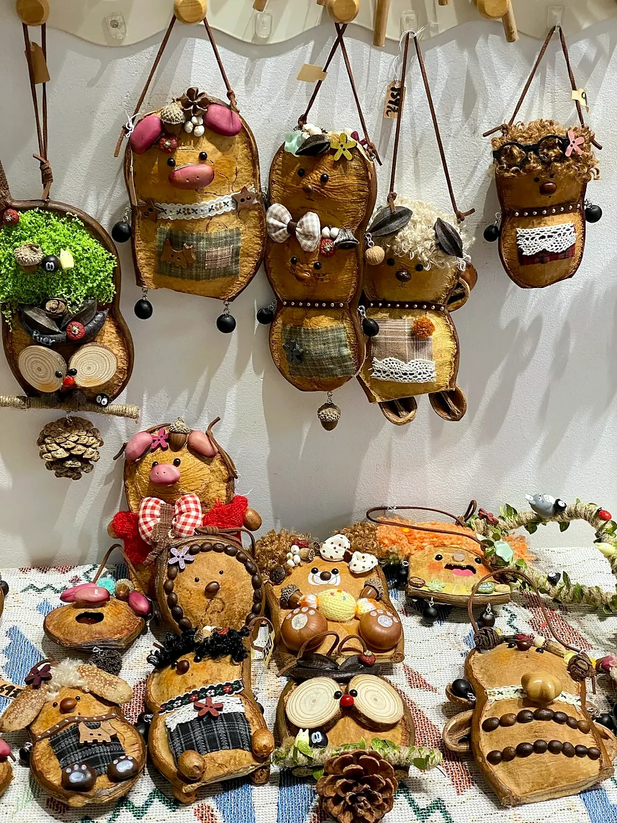 Collection of handmade Poddolls displayed on a studio wall and table