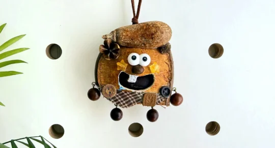Open-mouth handmade Poddoll character hanging against a warm wall display