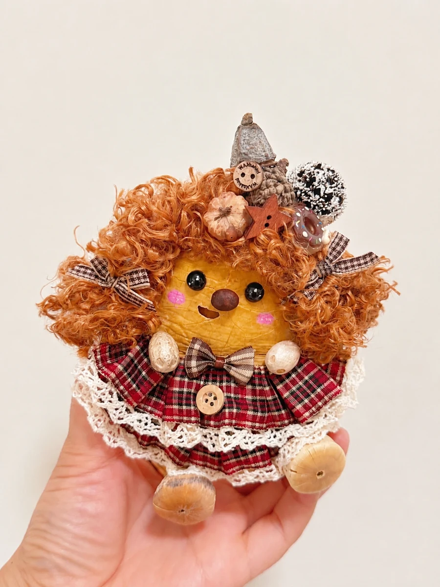 Handmade Poddoll character with curly hair and a red plaid dress
