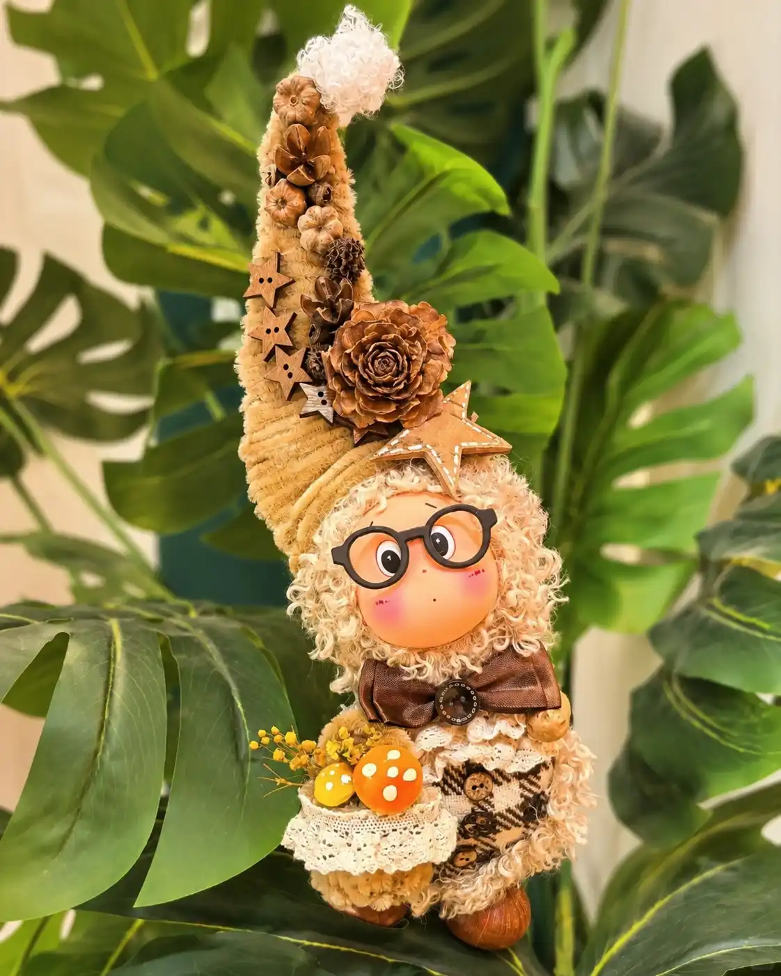 Small handmade Poddoll displayed among green plant leaves as a personal gift alternative