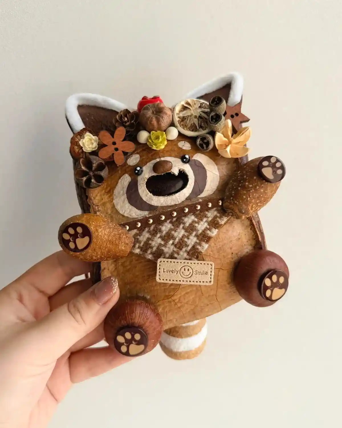 Small handmade Poddoll gift held against a simple background
