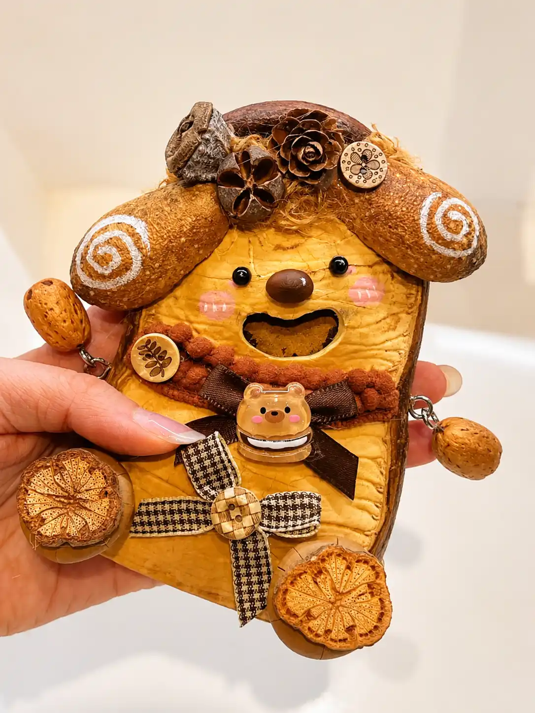 Smiling handmade dog-style Poddoll with natural ears, plaid ribbon, and wooden details