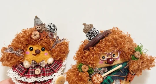 Two finished handmade Poddolls with different hair, clothing, and character details